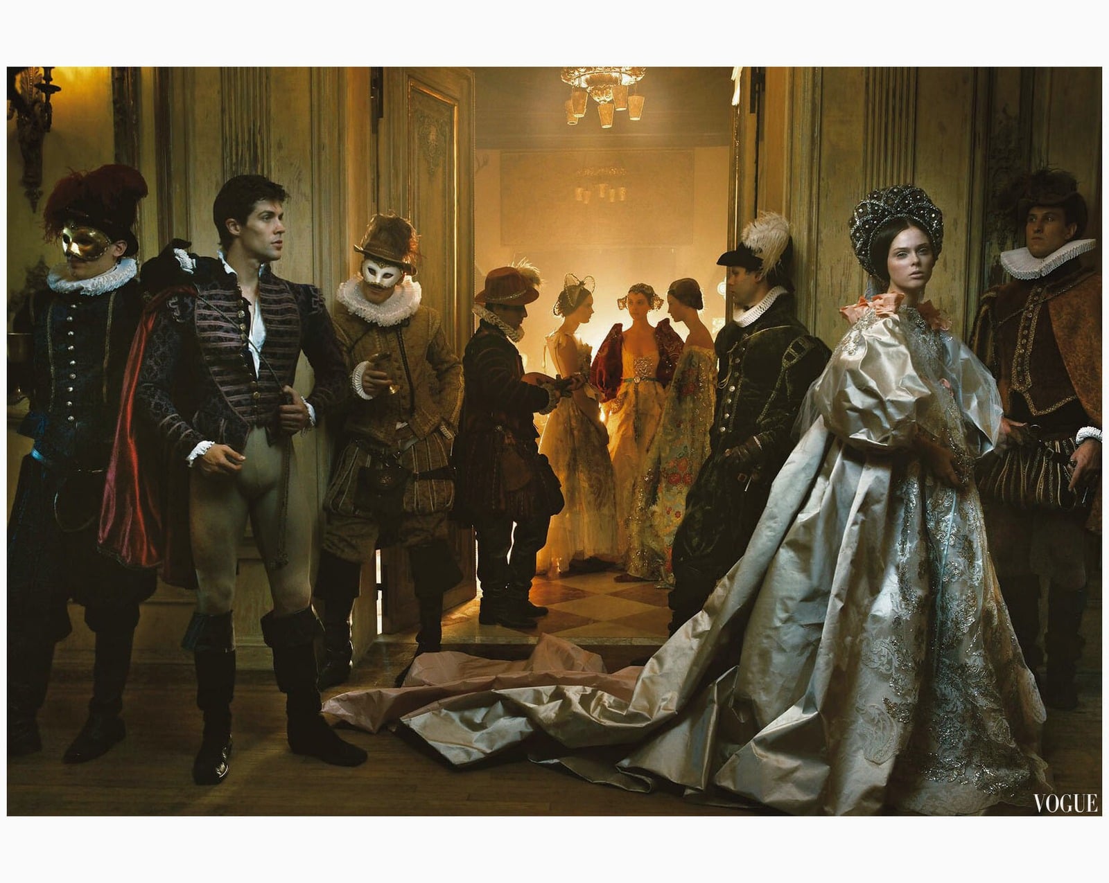 Magazine editorial page: models in Renaissance costume and masks in a paneled hall
